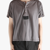 Grey shirt worn by a person, showing the shirt's fit