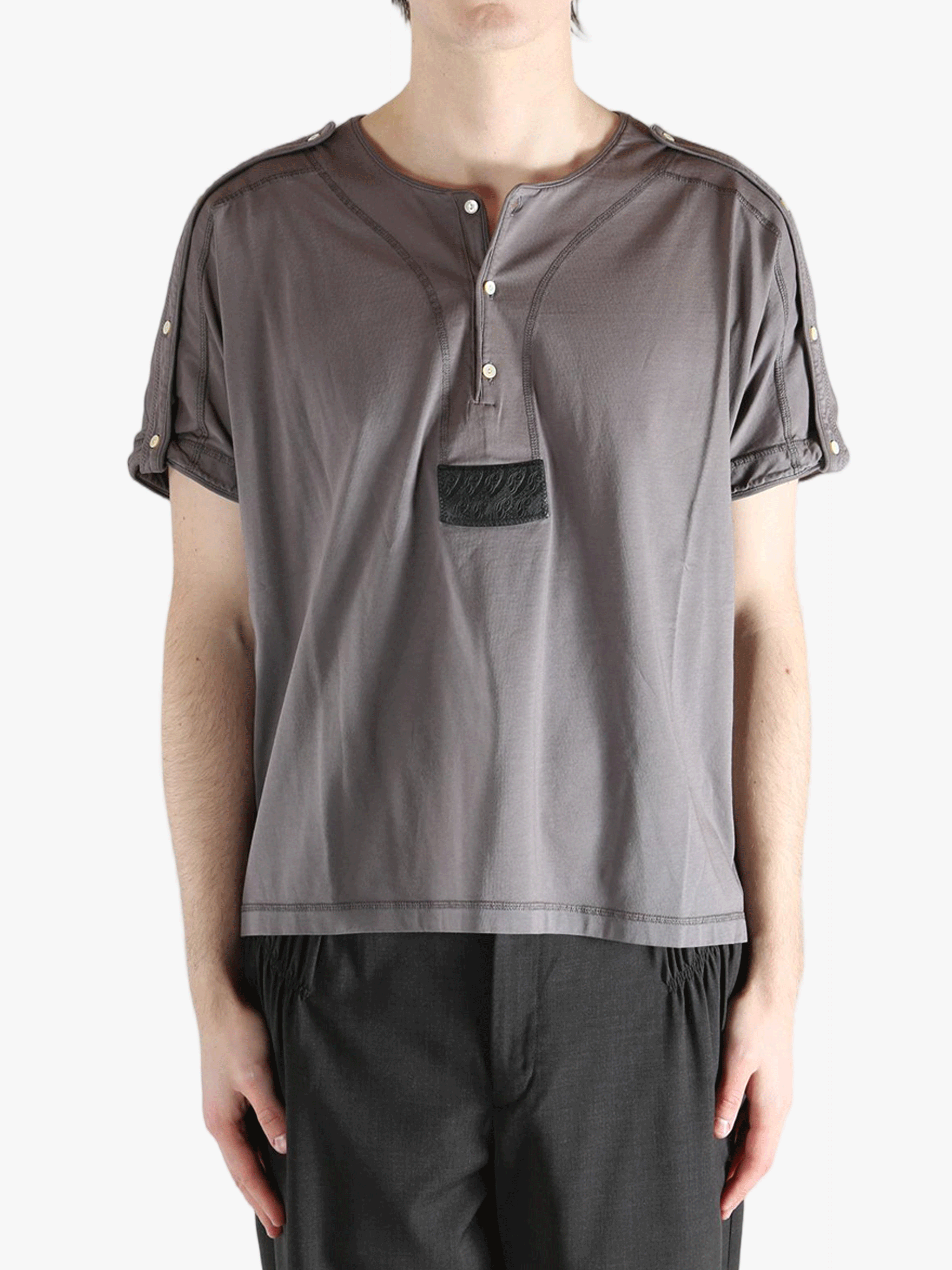 Grey shirt worn by a person, showing the shirt's fit