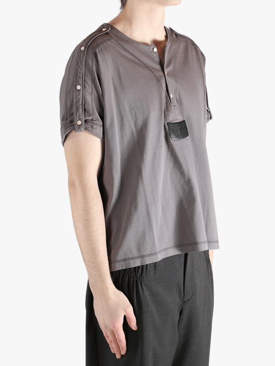 Grey shirt worn by a person, showing the shirt's fit
