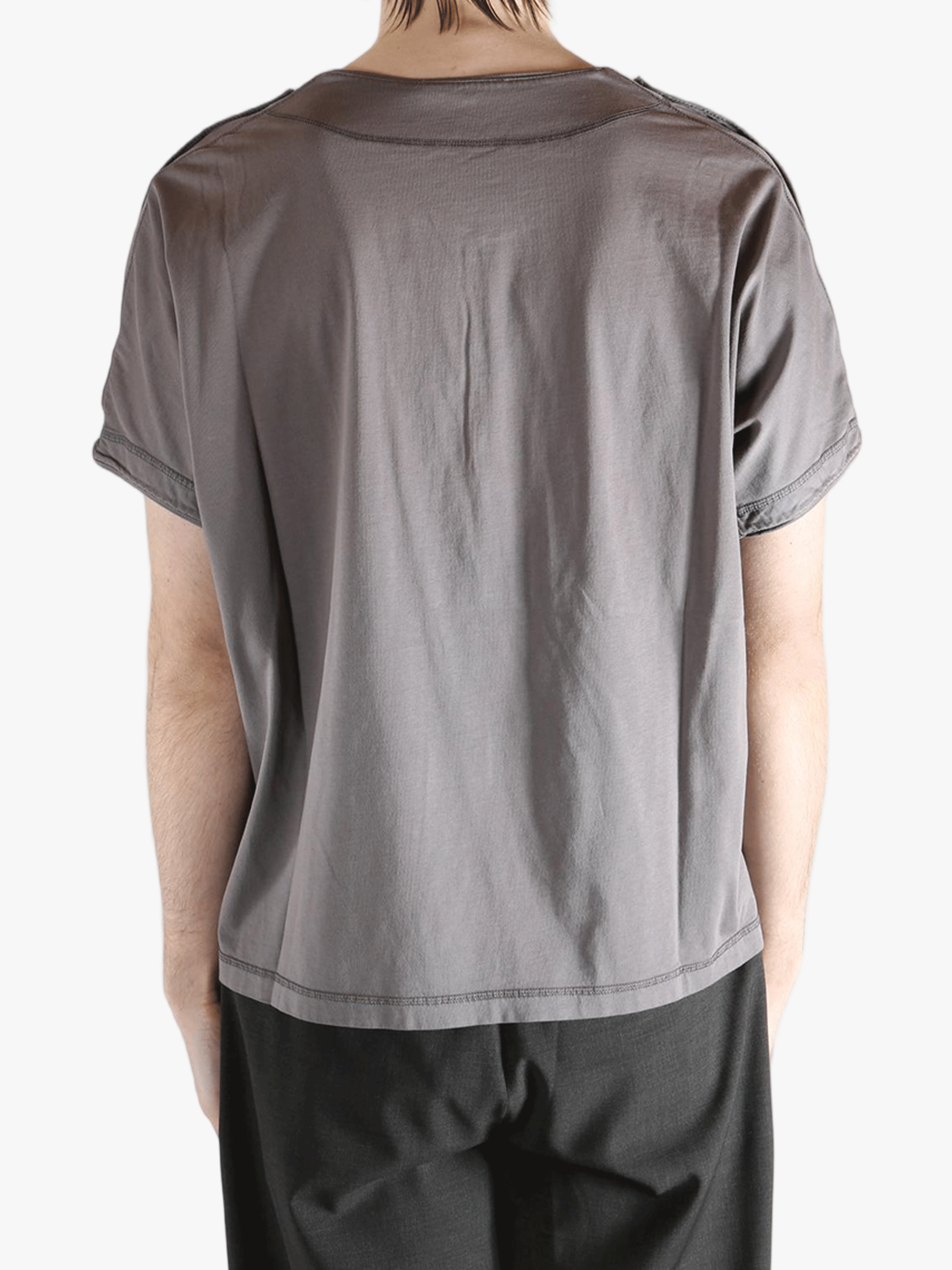 Grey shirt worn by a person, showing the shirt's fit