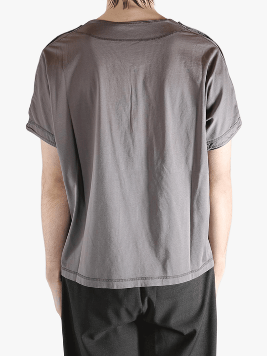 Grey shirt worn by a person, showing the shirt's fit