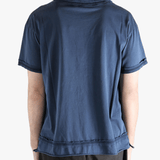 Blue polo shirt worn by a person, showing the shirt's fit