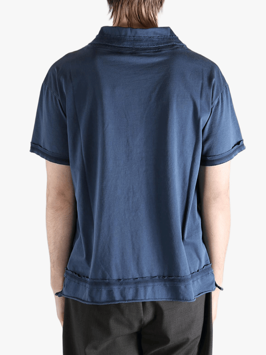 Blue polo shirt worn by a person, showing the shirt's fit