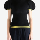 Black tops worn by a person, showing the top fit