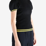 Black tops worn by a person, showing the top fit