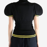 Black tops worn by a person, showing the top fit