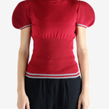 Red top worn by a person, showing the top's fit