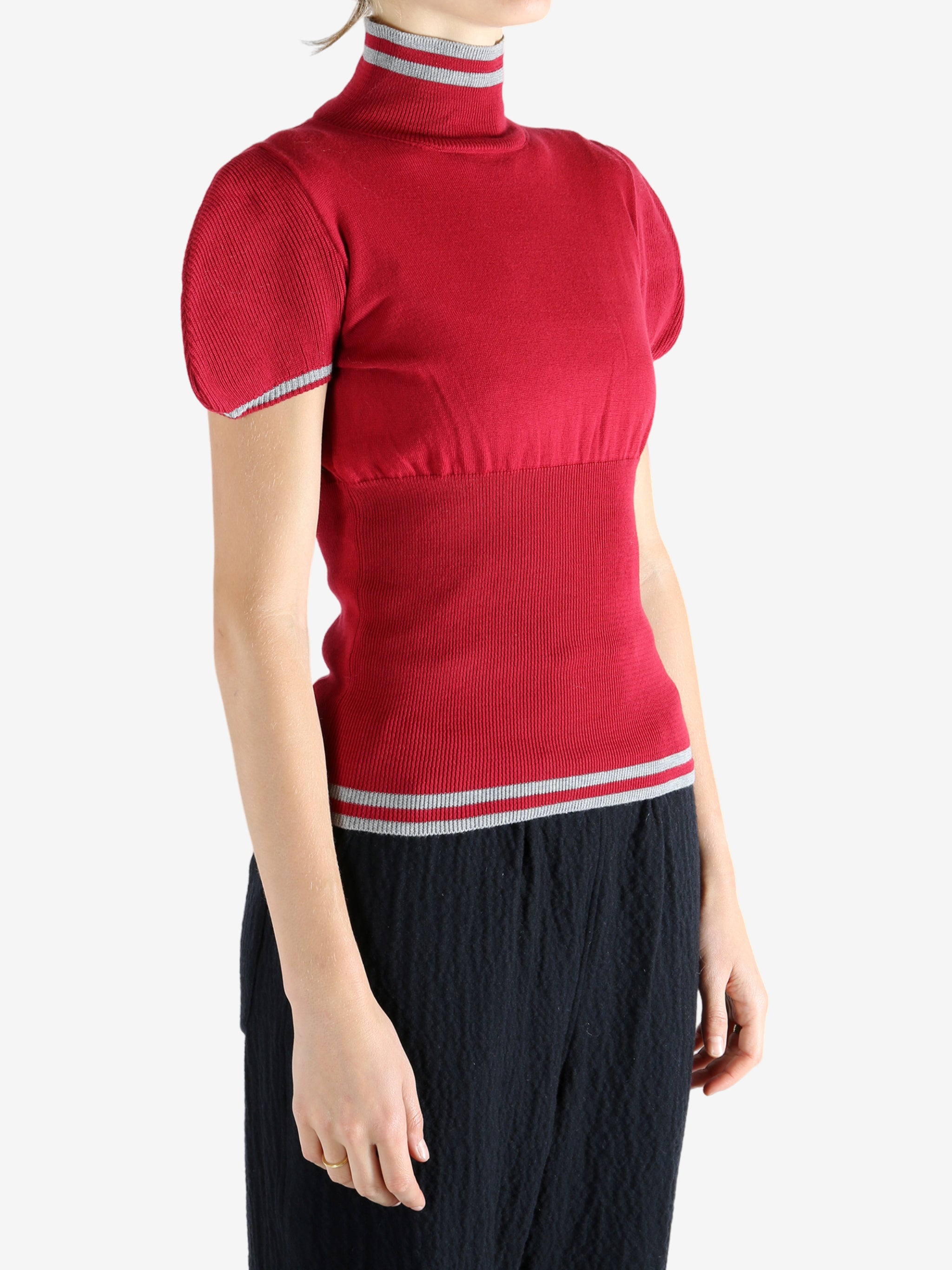 Red top worn by a person, showing the top's fit