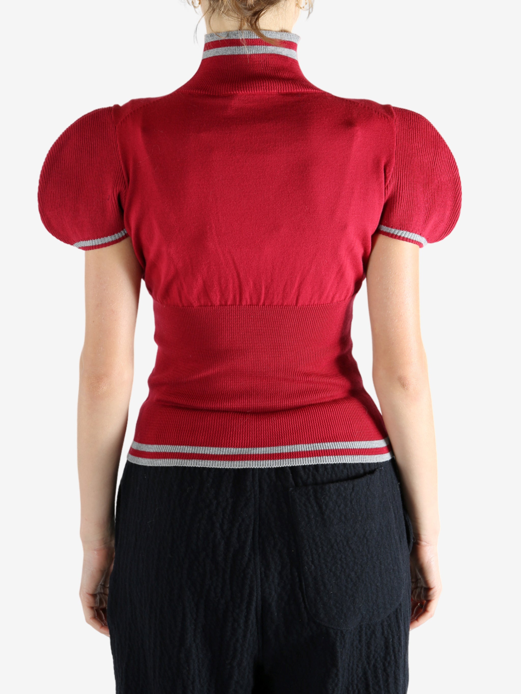 Red top worn by a person, showing the top's fit
