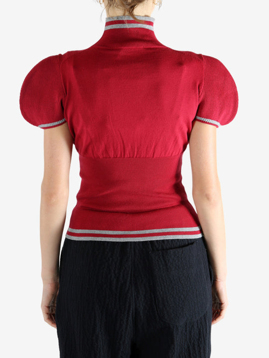 Red top worn by a person, showing the top's fit