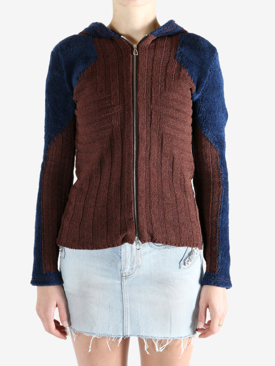 Burgundy knitwear worn by a person, showing the knitwear's fit