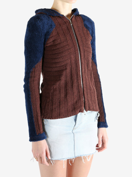 Burgundy knitwear worn by a person, showing the knitwear's fit