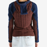 Burgundy knitwear worn by a person, showing the knitwear's fit