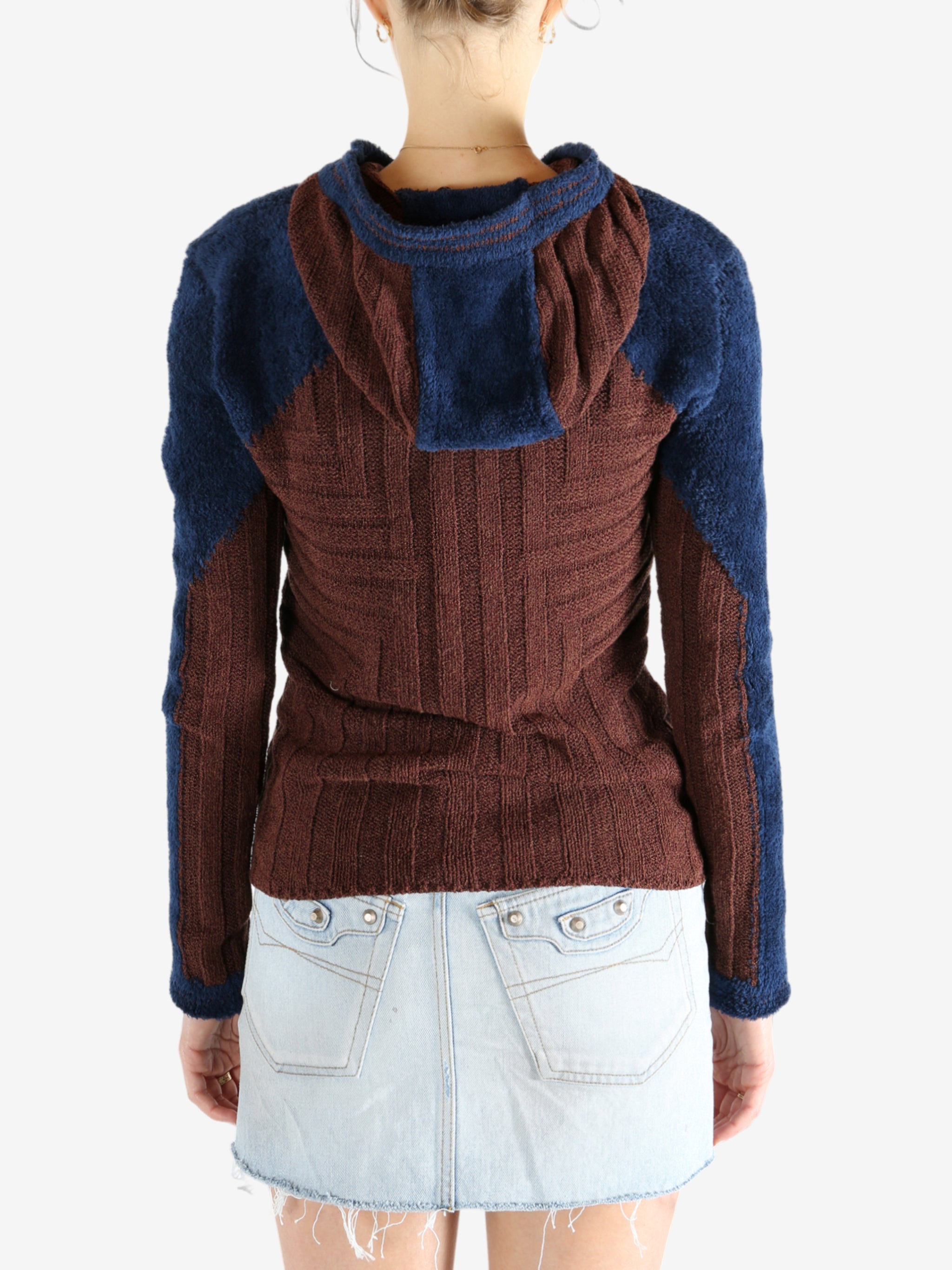Burgundy knitwear worn by a person, showing the knitwear's fit
