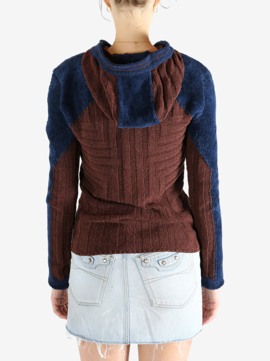 Burgundy knitwear worn by a person, showing the knitwear's fit