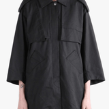 Black jacket worn by a person, showing the jacket fit