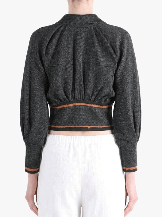 Black jacket worn by a person, back view