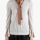 white top worn by a person, showing the top fit