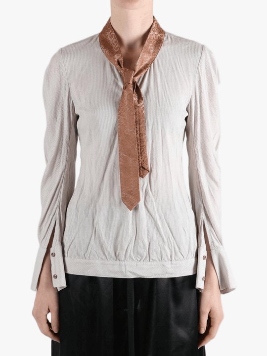 white top worn by a person, showing the top fit