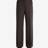 Brown pants worn by a person, showing the pants fit