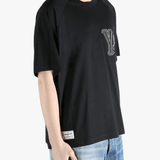 black t-shirts worn by a person, showing the t-shirts fit