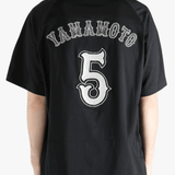 black t-shirts worn by a person, showing the t-shirts fit