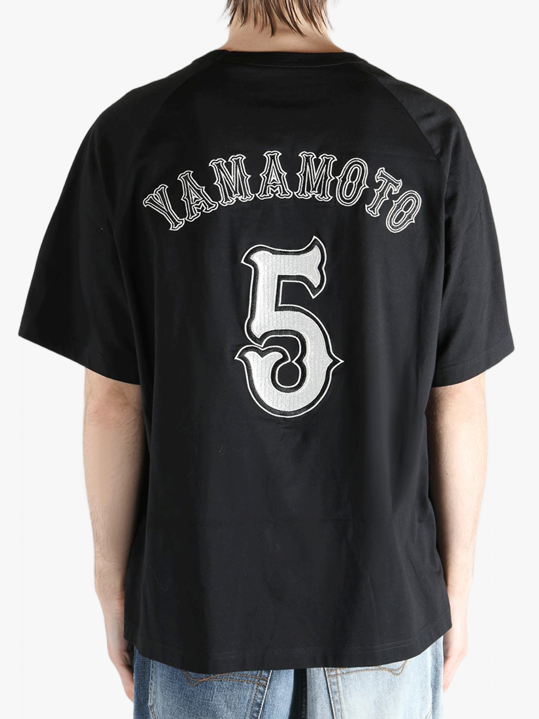 black t-shirts worn by a person, showing the t-shirts fit