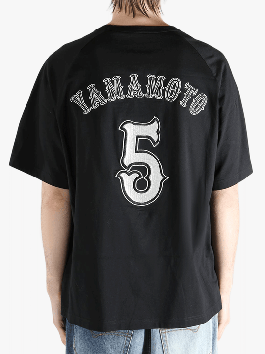 black t-shirts worn by a person, showing the t-shirts fit