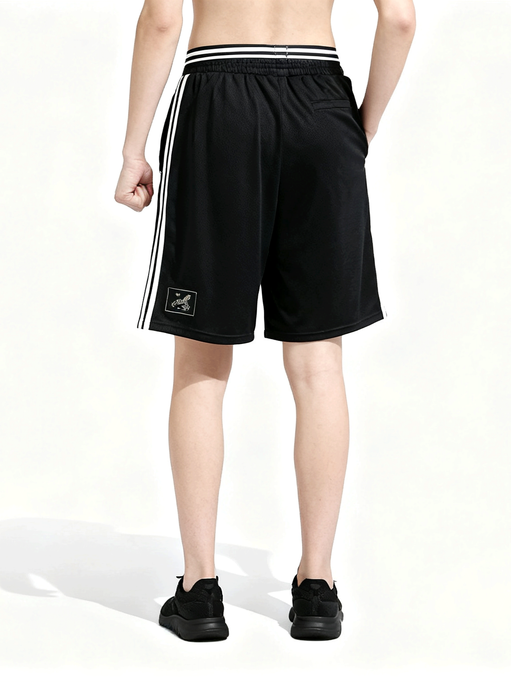 Black shorts worn by a person, back view