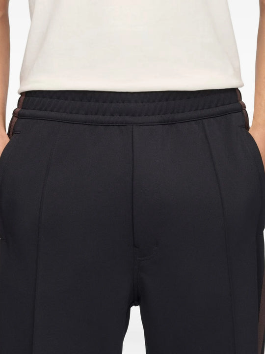 Navy pants worn by a person, showing the pants fit
