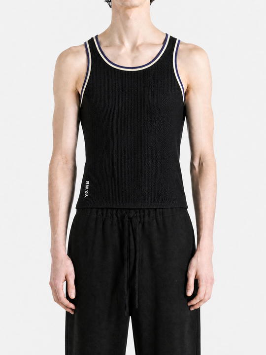 Black top worn by a person, showing the top fit