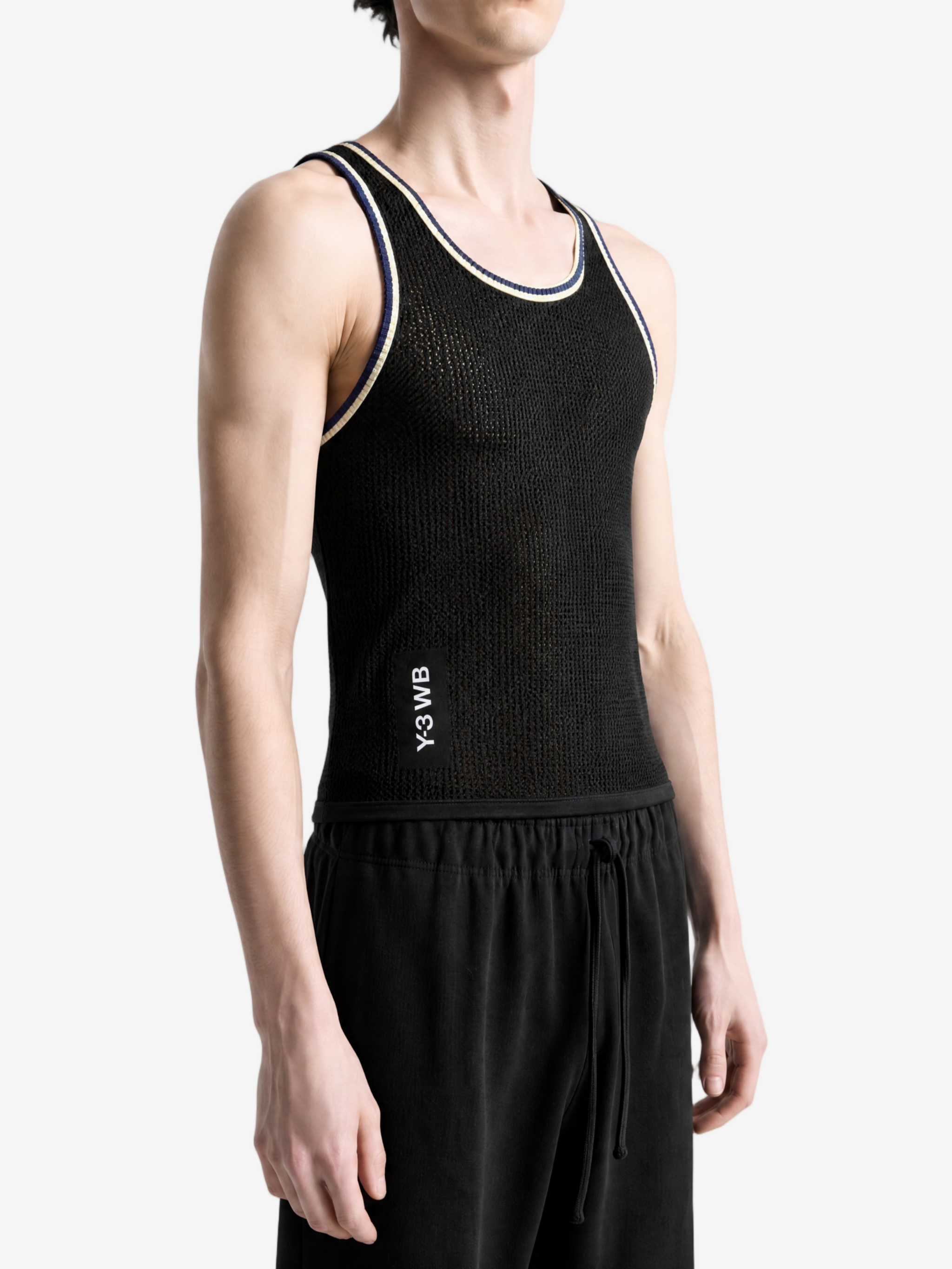 Black top worn by a person, showing the top fit
