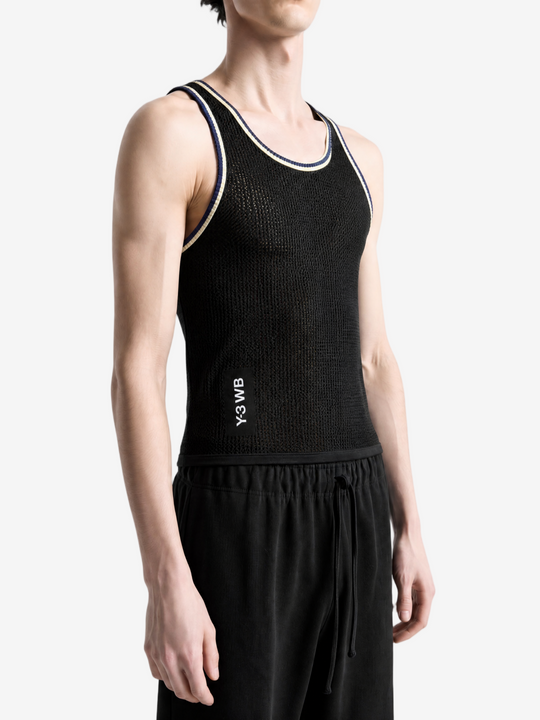 Black top worn by a person, showing the top fit