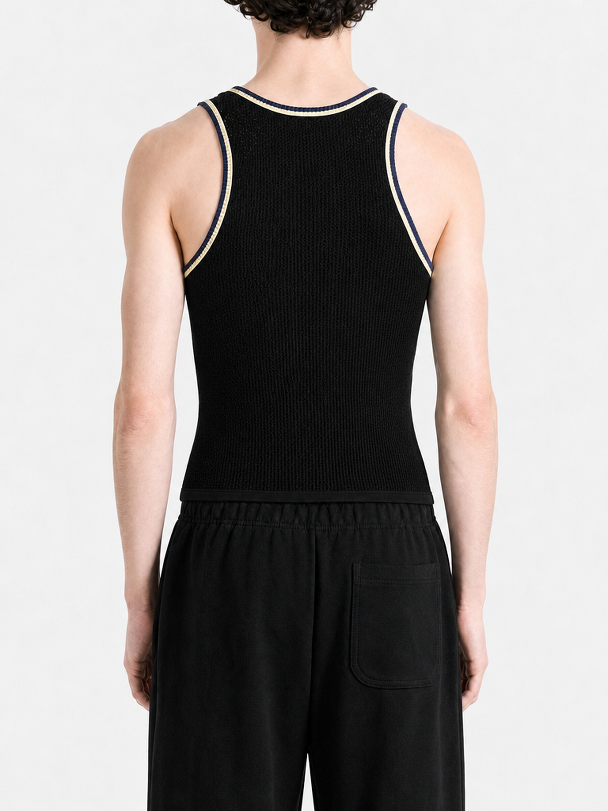 Black top worn by a person, showing the top fit