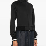 Black jacket worn by a person, showing the jacket fit