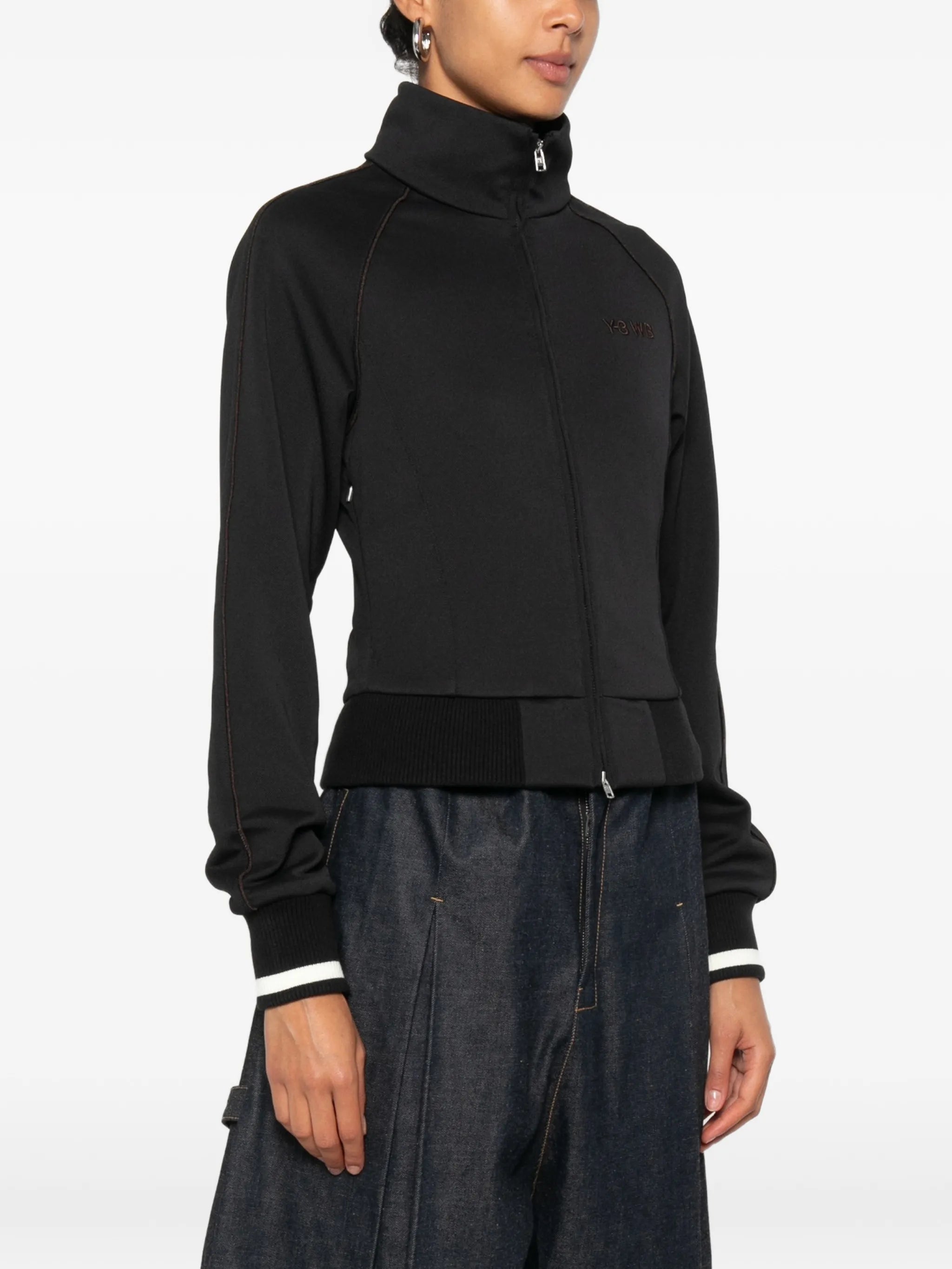 Black jacket worn by a person, showing the jacket fit