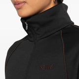 Black jacket worn by a person, showing the jacket fit
