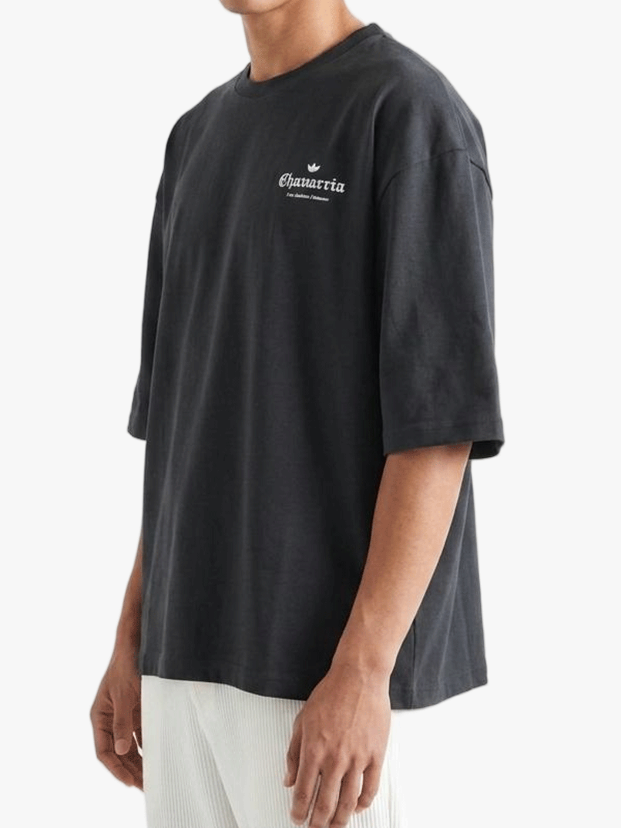 Black t-shirt worn by a person, side view