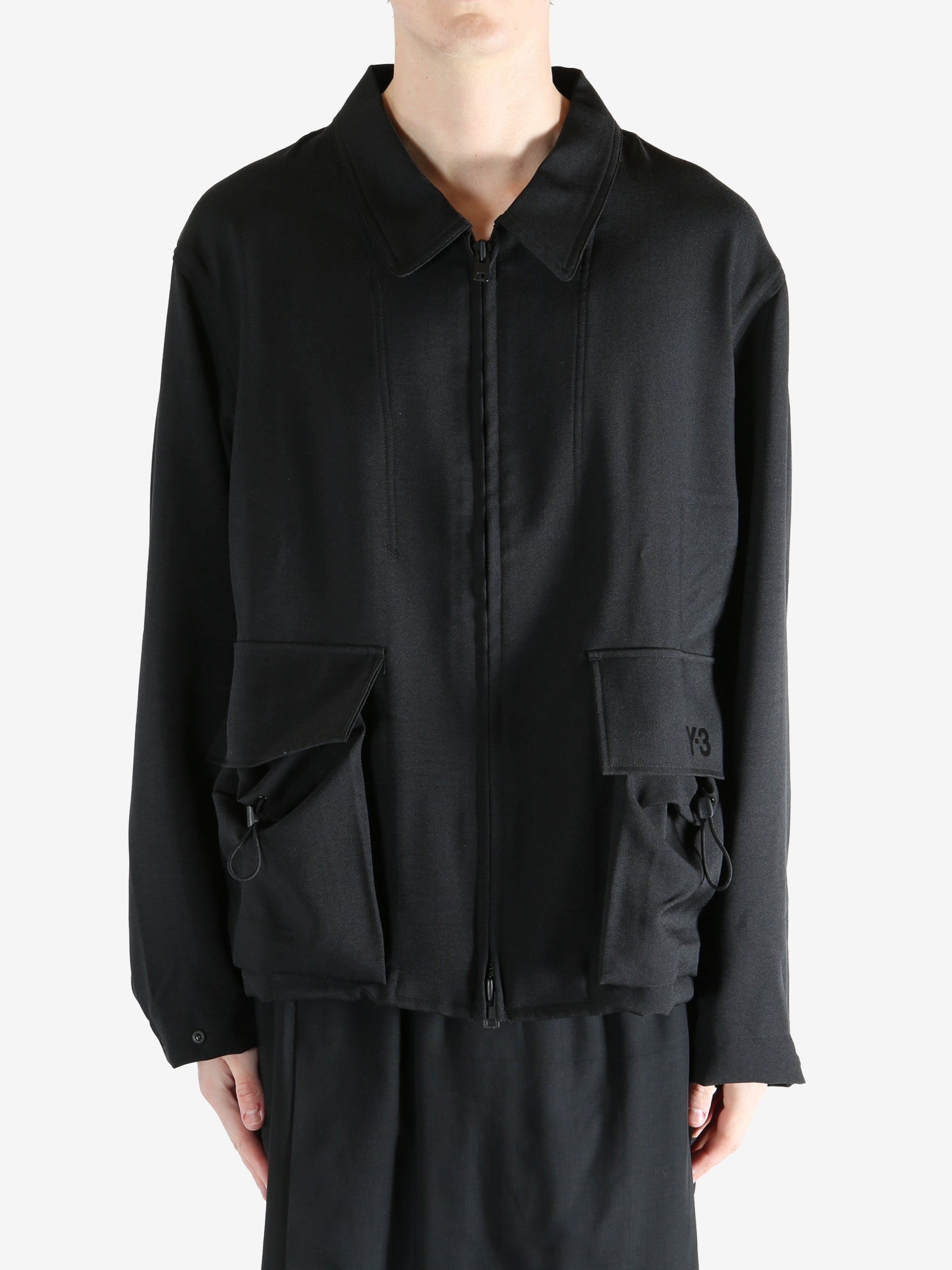 Black jacket worn by a person, showing the jacket fit