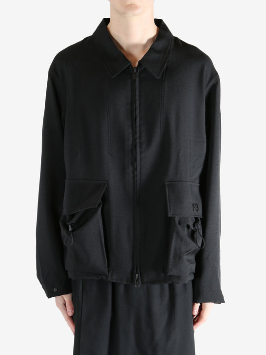 Black jacket worn by a person, showing the jacket fit