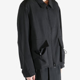 Black jacket worn by a person, showing the jacket fit