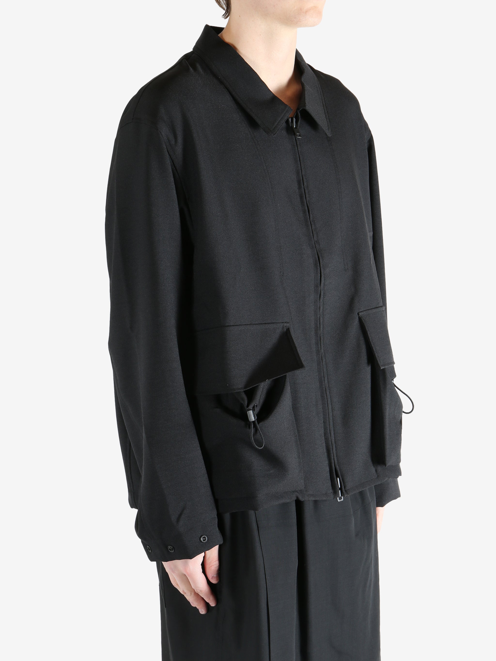 Black jacket worn by a person, showing the jacket fit