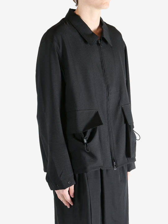 Black jacket worn by a person, showing the jacket fit