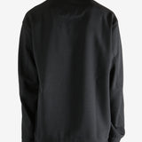 Black jacket worn by a person, showing the jacket fit