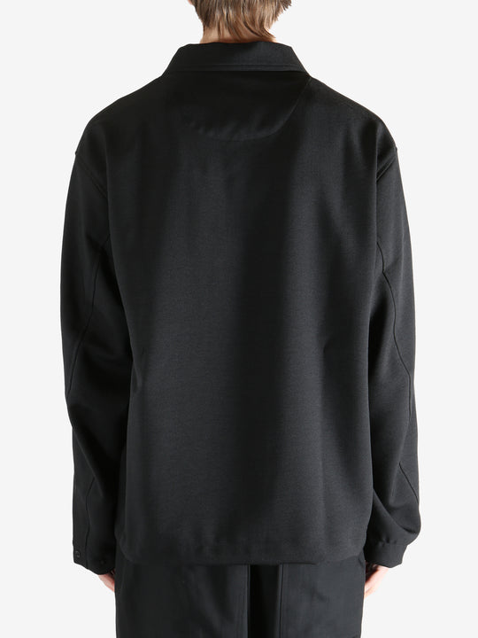 Black jacket worn by a person, showing the jacket fit