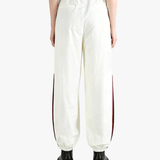 White pants worn by a person, showing the pants fit