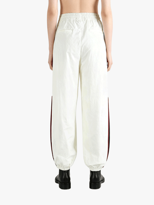 White pants worn by a person, showing the pants fit