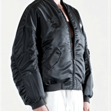 Grey jacket worn by a person, side view