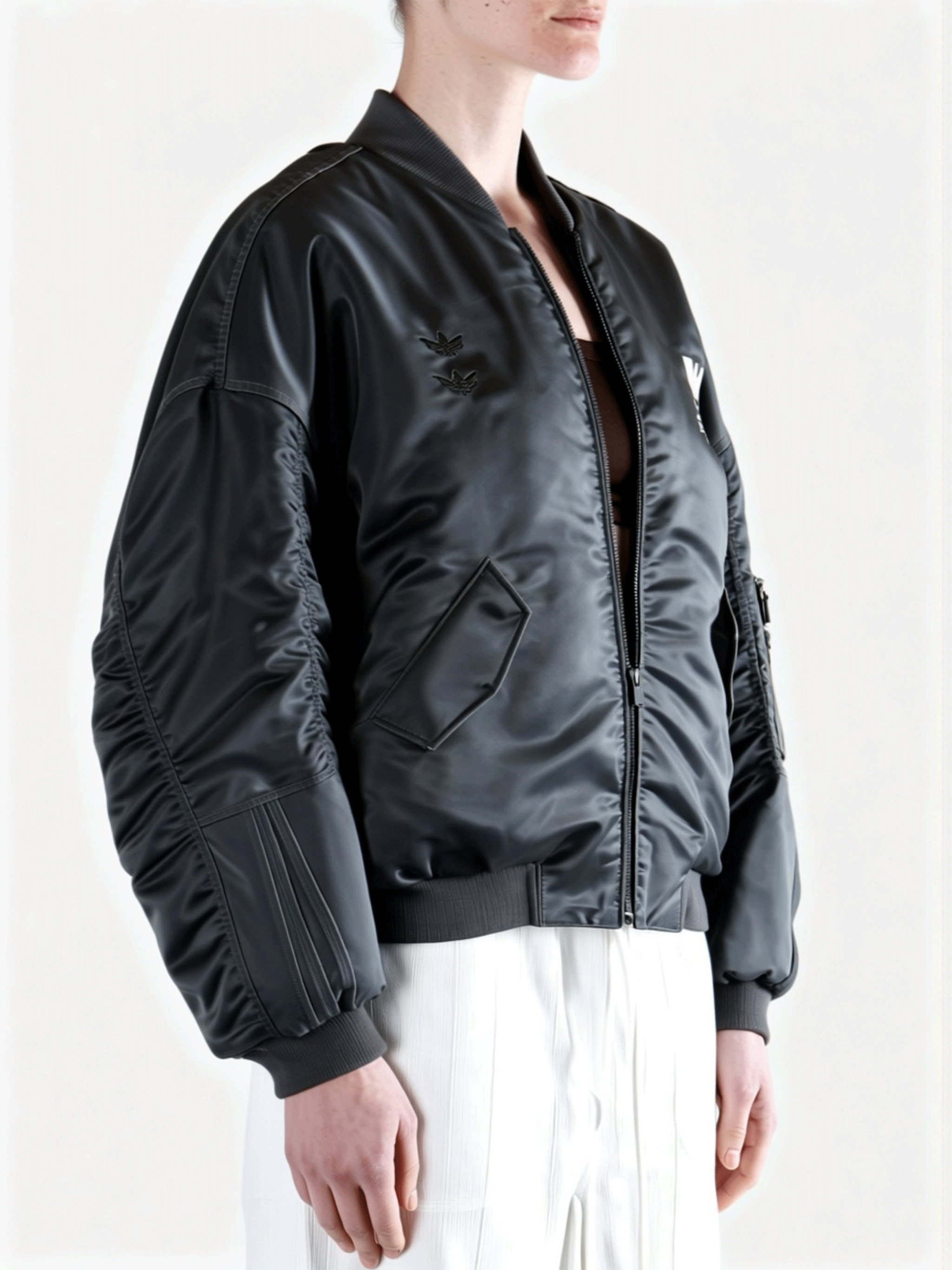 Grey jacket worn by a person, side view