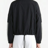 Black jacket worn by a person, back view